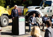 WSDOT Secretary Millar Issues Departing Warning to Policymakers Roger Millar standing at a podium for a photo op