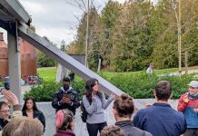Rinck Retools Housing Affordability Bonus with More Density Alexis and Shaun stand in a picnic area with trees and the pipes and beams of Gas Works in the background.