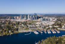 2025 Is Poised To Be the Year of the Eastside An aerial photo of Downtown Bellevue in 2023 on a sunny day, with blue Lake Washington in the foreground