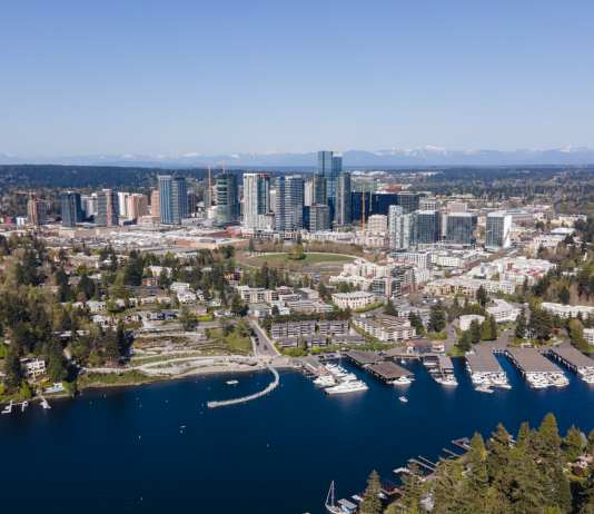 2025 Is Poised To Be the Year of the Eastside An aerial photo of Downtown Bellevue in 2023 on a sunny day, with blue Lake Washington in the foreground