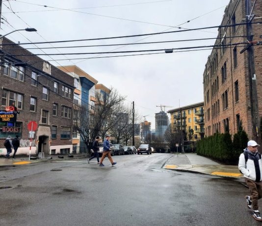 Seattle Reveals Midrise Zoning Proposal for Phase 2 of Growth Plan Pedestrians cross Denny Way at the Harvard Avenue intersection with midrise apartment buildings in the background.