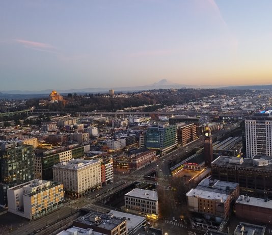 Seattle Planning Commission Pushes for Bolder Housing Growth Strategy A view from the Smith Tower at dusk looking toward Beacon Hill with Mount Rainier in the distance