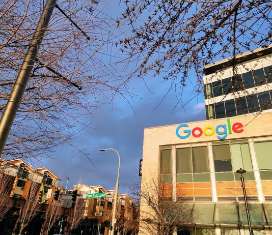 After Density Debate, Kirkland Plans for Future 10-Minute Neighborhoods Google's logo is illuminated in the sun at the Kirkland Urban building in Downtown Kirkland. A row of townhouses sits behind.