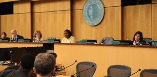 In the foreground are OPCD planners and in the background are city councilmembers at the dais.