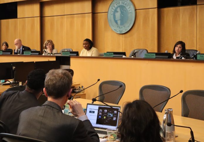 Seattle City Council and OPCD In the foreground are OPCD planners and in the background are city councilmembers at the dais.