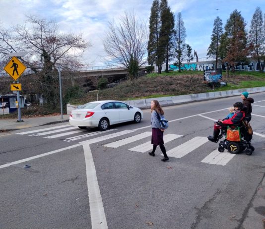 I-90 Ramps Will See Safety Upgrades Ahead of Judkins Park Station Opening Two people crossing the ramp with one car already having disregarded them. One person is in a wheelchair.