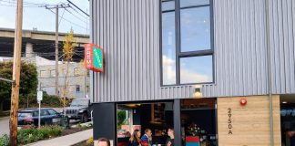 Statewide Neighborhood Cafe Bill Returns, Expanded to More Types of Businesses A small neighborhood cafe commercial storefront with people sitting outside in patio chairs