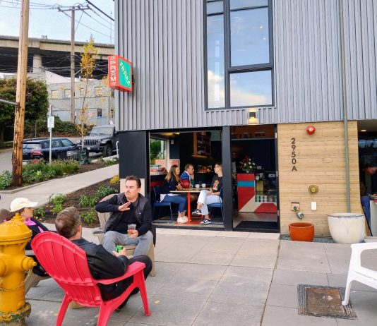 Statewide Neighborhood Cafe Bill Returns, Expanded to More Types of Businesses A small neighborhood cafe commercial storefront with people sitting outside in patio chairs