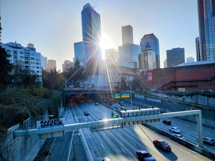 I-5 through Seattle Cars use Interstate 5 through Seattle on a sunny day, with the sun just breaking through the city skyline