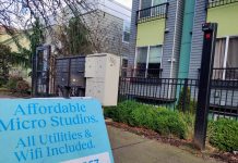 Rent Stabilization Tops Washington Democrats’ Housing Agenda for 2025 Session A sign in front of an apartment building advertising "Affordable Micro Studios" with utilities and wifi included