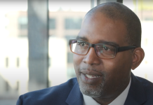 Longtime Tukwila Councilmember De’Sean Quinn Joins King County Council Quinn is a black man with glasses and wears a suit.