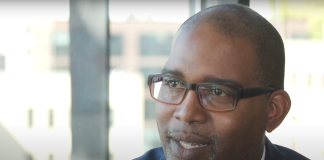 Longtime Tukwila Councilmember De’Sean Quinn Joins King County Council Quinn is a black man with glasses and wears a suit.