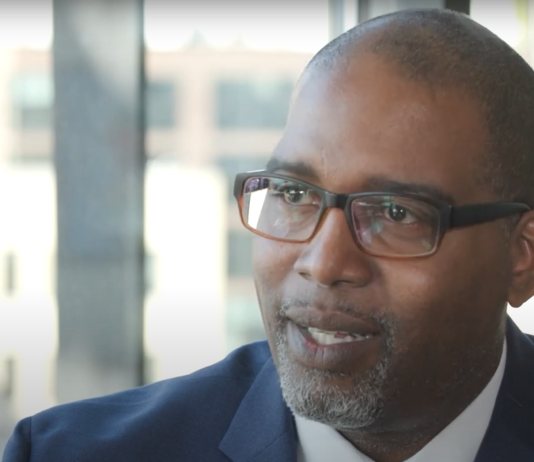 Longtime Tukwila Councilmember De’Sean Quinn Joins King County Council Quinn is a black man with glasses and wears a suit.