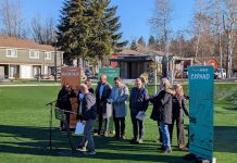 Op-Ed: King County Parks Levy Is Vote for Strong, Equitable Communities for All A line of eight officials stand in front of banners that say Maintain, Enhance, and Expand.