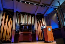 Harrell Teases Plans for Pedestrianizing Pike Place and Overhauling Aurora Avenue Harrell stands at a lectern with a big pipe organ behind him on the Benaroya auditorium stage.