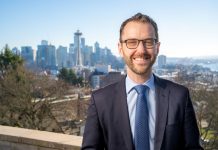 Op-Ed: End Cash Bail for Nonviolent Misdemeanors A white man in glasses and suit poses in from of the Seattle skyline
