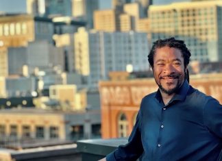 OPCD Further Trims Corridor Upzones in Newly Unveiled Seattle Zoning Maps Rico is a Black man with braids and a button up shirt posing in front of the Seattle skyline