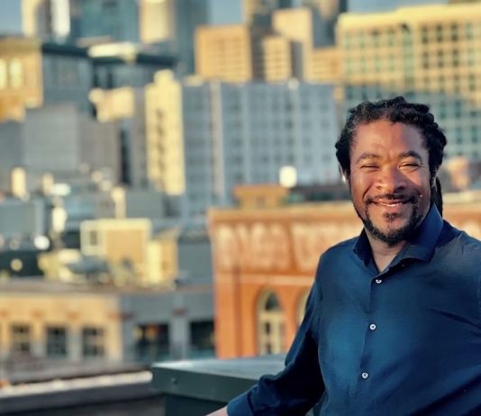 OPCD Further Trims Corridor Upzones in Newly Unveiled Seattle Zoning Maps Rico is a Black man with braids and a button up shirt posing in front of the Seattle skyline