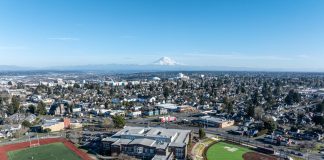 An aerial shot of North Tacoma neighborhoods with Mount Rainier and the Tacoma Dome in the distance.