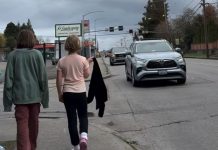 Op-Ed: Bremerton’s Multimodal Future at Crossroads with 6th Street Project Two girls walk down 6th narrow sidewalk as cars zip by. One draps a jacket over her shoulder.
