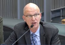 Harrell Sacks Seattle Construction Director as Clock Ticks on Permitting Reform Torgelson wears glasses, a blue checkered tie and a dark suit.