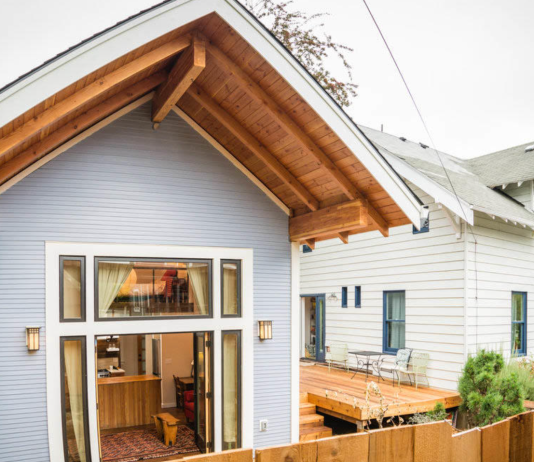 Snohomish County Relaxes Urban Accessory Dwelling Rules Ahead of State Deadlines A small cottage with its doors open, revealing living room, behind a larger parent house