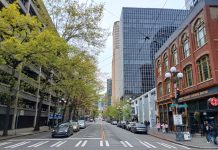 Op-Ed: It’s Time to Bring Transit Back to Seattle’s First Avenue A view north up First Avenue shows a hodge of Pioneer Square historic brick buidlings, tall glass scrapers and a large parking garage.