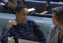 Auditor Criticizes Seattle’s Approach to Gun Violence, Deputy Mayor Fires Back Washington is a black woman with short hair. She holds the microphone and looks to her left toward Natalie Walton-Anderson and the auditor as she delivers her rebuttal.