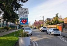 State Bill Could Unleash Potential of Streets, Making Space for People A concrete planter narrow the crossing distance at an intersection with a sign saying "Street closed, local access only, Stay Healthy Street."