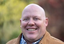 Union Leader Jamie Fackler Enters D2 Seattle Council Race Jamie is a bald middle-aged man wearing a light brown coat.