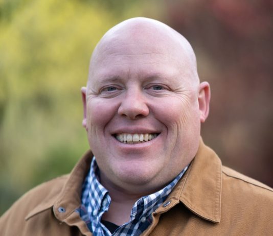Union Leader Jamie Fackler Enters D2 Seattle Council Race Jamie is a bald middle-aged man wearing a light brown coat.