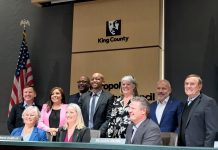 King County Restructures School Impact Fees to Comply with State Law Shannon Braddock takes a seat in the middle of the dais with the nine County Councilmembers around her during her swearing in ceremony.