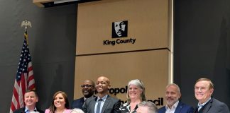 King County Restructures School Impact Fees to Comply with State Law Shannon Braddock takes a seat in the middle of the dais with the nine County Councilmembers around her during her swearing in ceremony.