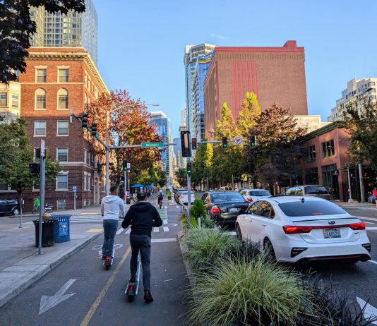 Seattle’s Scooter and Bikeshare Boom Reaches New Heights Two riders push off to accelerate on their Lime scooters on the Second Avenue protected bike lane in Belltown.