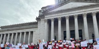 Op-Ed: Washington Landlords Spending Big, Playing Dirty to Block Rent Stabilization Hundreds of advocates hold signs on the steps of the Capitol Building.