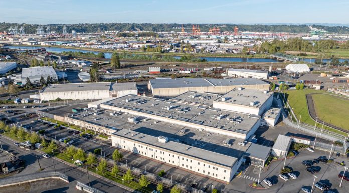 Op-Ed: It’s Time to Uproot ICE Penal Colonies Like Tacoma’s GEO The two-story detention center has white walls and is surrounded by asphalt parking.