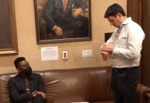 Op-Ed: Why Educators Staged a Sit-In in Governor Ferguson’s Office Shane Esquibel answers a call coming through on his smartwatch, as Scott sits and looks in from the Governor's waiting room, adorned with official portraits of governors long past.
