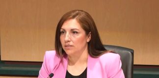 Mosqueda sits at the dais. She is a Latina wearing a hot pink blazer.