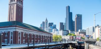 King Street Station with the downtown Seattle skyline in the background on a clear sunny day.