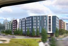 In Eastside Affordable Housing Efforts, ARCH Provides Both Help and Hurdles A rendering shows a light rail window with a view of a large blue six story building with a big green lawn in front.