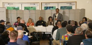 High Point Safety Town Hall Is a Low Point for Saka Police Chief Shon Barnes sits at the center of the panel and Saka stand in front the table with the mic.