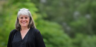 Balducci Claims County Executive Race Lead, John Wilson Mired in Scandal Balducci has her glasses up on her head and smiles. She stands in front of a forest.