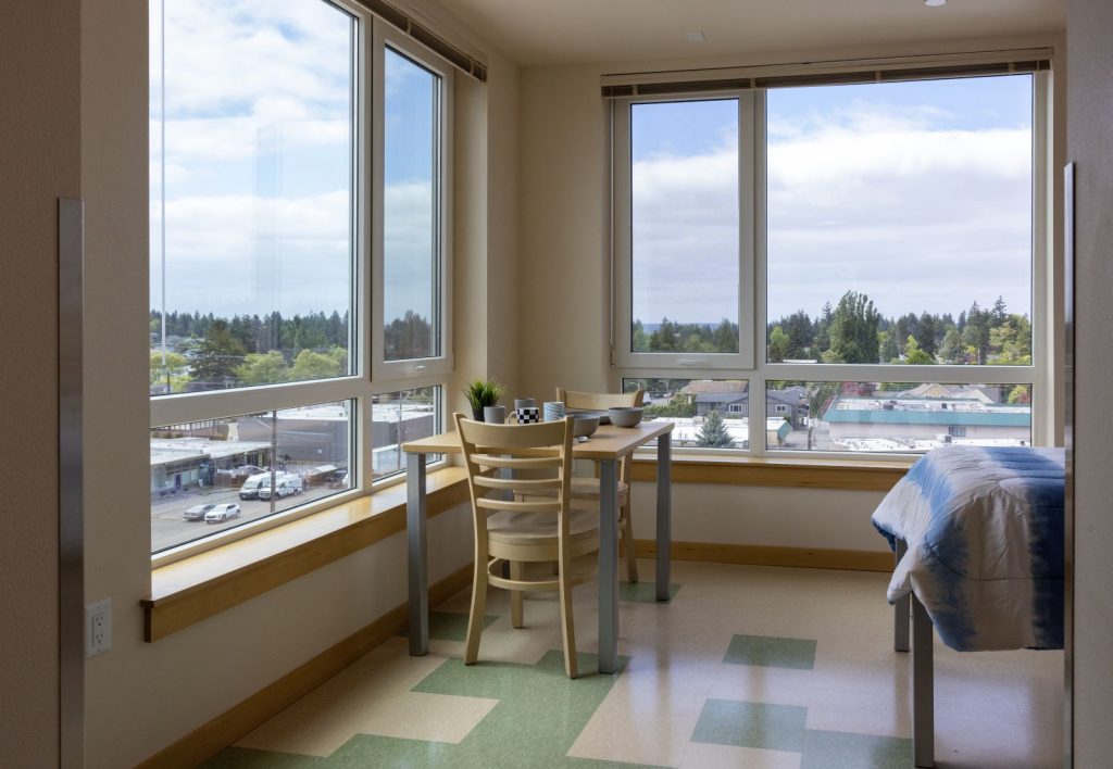 Large corner window provide plenty of light for a small dining room table.