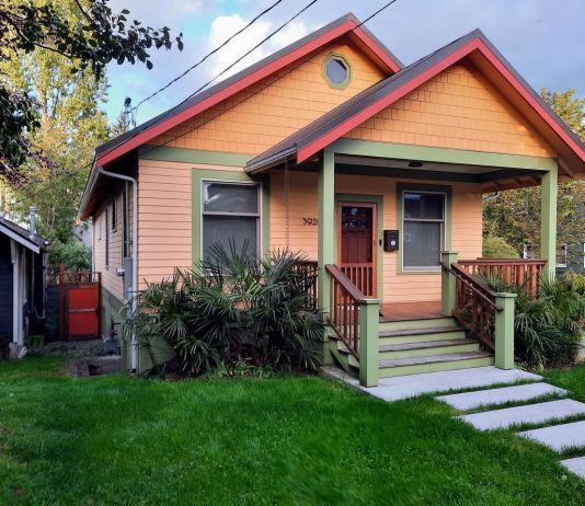 Seattle Eases Accessory Dwelling Restrictions Just Ahead of State Deadline A peach-colored house with teal trim and a grassy lawn