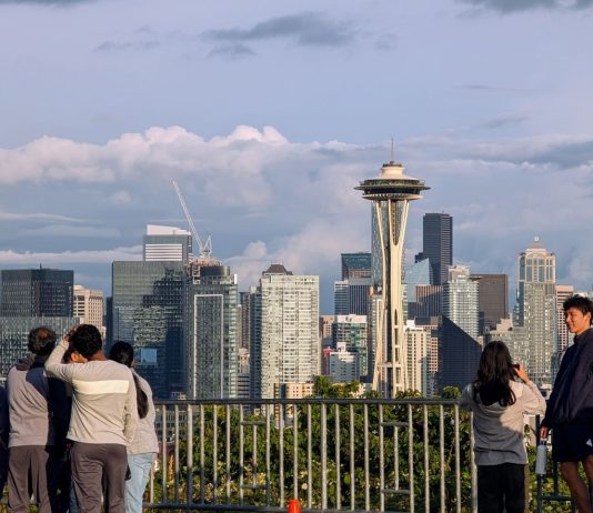 Seattle’s Population Blows Past 800,000 in Latest State Estimates A group of young people stand by the railing at Kerry Point with the Space Needle and downtown skyscrapers looming in the distance.