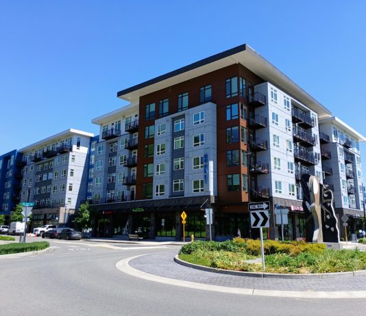 Sammamish Council Pursues Denser Town Center Vision Amid Backlash A six story apartment building in Sammamish next to a roundabout