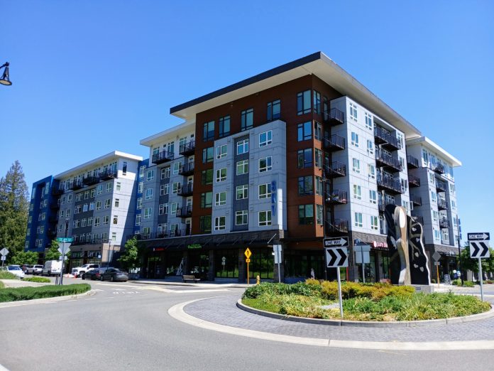 Town Center building Sammamish A six story apartment building in Sammamish next to a roundabout