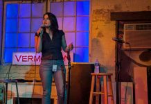 Rinck Backs Capitol Hill Crisis Center, Other Seattle Officials Coy Rinck holds the mic on the Vermillion stage. She has long dark hair and a nose piercing.