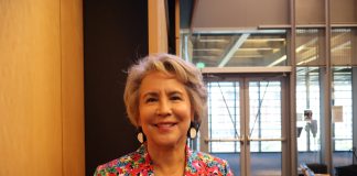 Seattle Council Appoints Debora Juarez to Fill District 5 Vacancy A native woman with grey hair wearing a loud, floral print suit