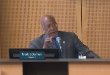 Nelson, Saka Boycott Housing Committee, Blocking Seattle Renters Commission Appointments Solomon is a Black man wears a suit and glasses. He sits at the Council Chambers dais.